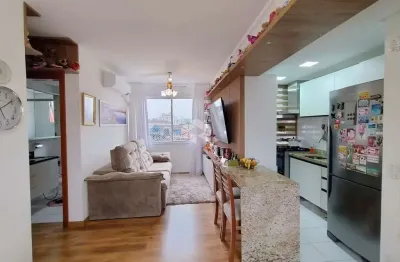 Apartamento 2 dormitórios, uma suíte, 1 vaga de garagem, living com churrasqueira, mobiliado com móveis planejados.