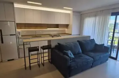 Apartamento em home club completo na praia brava com vista parcial do mar