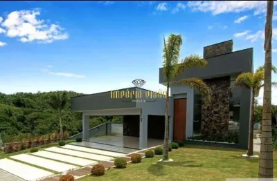 Casa de alto padrão à venda com 3 suítes, sendo 1 master e piscina no condomínio reserva ibirapitanga - santa isabel-sp