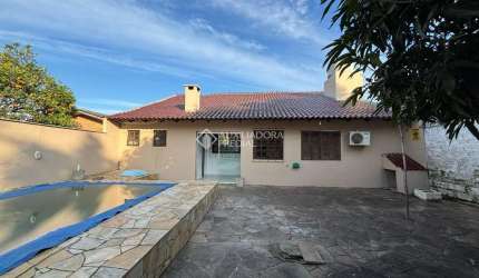 Casa em condomínio fechado com 3 quartos à venda na Rua Chile, 661, Jardim Universitário, Viamão, 160 m2 por R$ 530.000