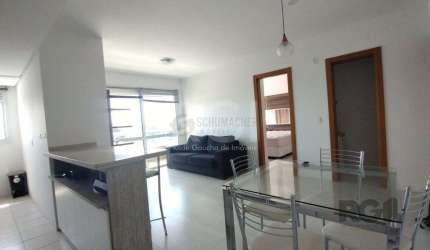 Apartamento mobiliado, 57m2, 1 suite, 1 vaga, lareira e churrasqueira, localizado no bairro Três Figueiras, Porto Alegre/RS.