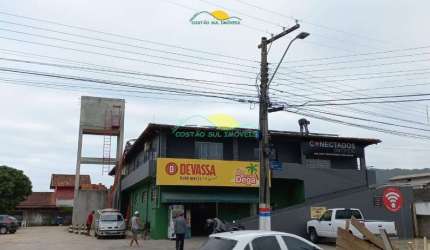 Prédio comercial na principal rua do bairro hoje há um mercado no térreo e uma igreja no piso super