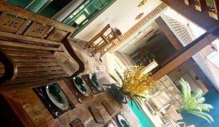 Casa alto padrão no bairro Cidade Jardim com três suítes e área gourmet.