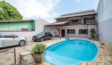 Casa com 5 dormitórios, 1 suíte, espaço gourmet e piscina. A venda no Bairro Rio Branco em Canoas-Rs