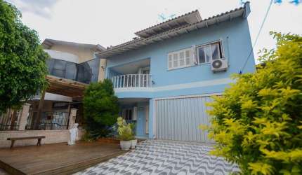 Sobrado com 5 quartos e 3 suítes no bairro Barnabé em Gravataí com amplo terreno