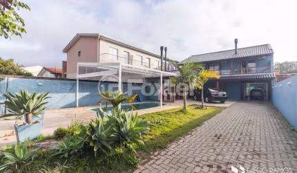 Casa com 4 quartos à venda na Rua Jerolomo Minuzo, 317, Vila Nova, Porto Alegre, 304 m2 por R$ 900.000