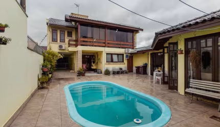 Casa em condomínio fechado com 4 quartos à venda na Travessa Porto Príncipe, 59, Jardim Lindóia, Porto Alegre por R$ 1.650.000