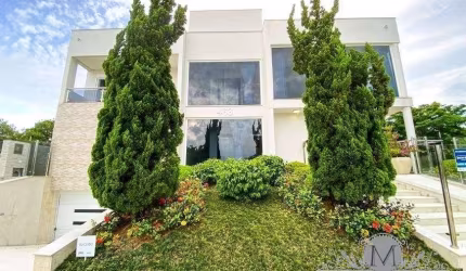Casa em condomínio fechado com 5 quartos à venda na Rua das Caraúnas, Jurerê Internacional, Florianópolis por R$ 7.900.000