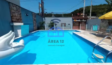 Sobrado à venda no bairro Martim de Sá em Caraguatatuba, 3 dormitórios, 3 banheiros, piscina, área