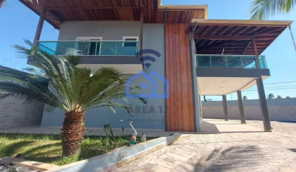 Lindíssimo sobrado com piscina e vista para o mar à venda no bairro Praia das Palmeiras em Caraguat