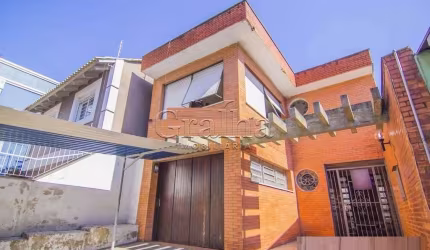 Casa com 4 quartos à venda na Rua Eudoro Berlink, 482, Auxiliadora, Porto Alegre por R$ 1.500.000