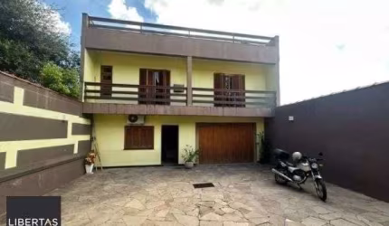 Ótima casa no bairro Jardim Lindóia, com 4 quartos, pátio amplo e área com churr