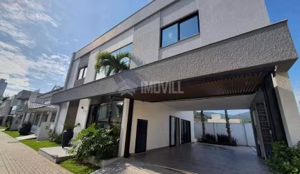 LINDA CASA NOVA EM CONDOMINIO FECHADO COM 4 SUÍTES E 4 VAGAS DE GARAGEM.