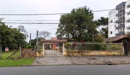 Casa térrea , hall de entrada, living 03 ambientes com lareira, sala de jantar, copa cozinha, circulação, 04 dormitórios , sendo uma suite, dependência de empregada, wc auxiliar, garagem coberta para 