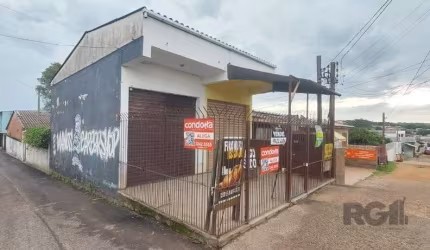 Imóvel de esquina, localizado no bairro Campo Novo. Terreno com duas lojas de frente para Av. Cristiano Kraemer, ambas alugadas, medindo 24m2 cada uma. Na sequência segue edificação de uma casa térrea