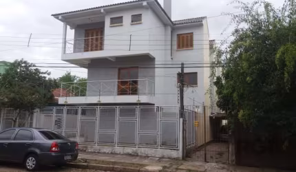 Casa  Nova Triplex com Três do dormitórios sendo uma suite , sacada , lareira na sala de  estar , três banheiros , duas vagas de garagem