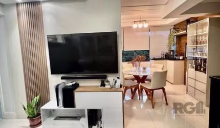 Vende-se apartamento semi mobiliado, no Bairro Cristo Redentor, com vista definida, 3 dormitórios com suíte, 2 vagas, living amplo com cozinha americana integrada com churrasqueira, área de serviço se