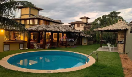 Vende casa em condomínio 04 suítes e area privativa com piscina e churrasqueira a 50m da praia de Manguinhos