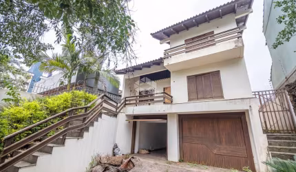 Sobrado comercial ou residencial, 3 dormitórios, sendo 1 suíte com closet e hidro, área intima com lareira. À venda no bairro Marechal Rondon/Canoas