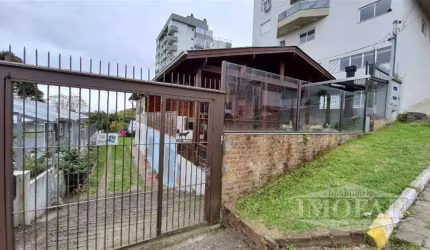 Casa mista, alvenaria e madeira, com 05 dormitórios, 03 salas, 03 cozinhas, 03 banheiros sociais, estacionamento e porão.  São três casas com entradas individuais.  Não pode ser financiada.  Área tota