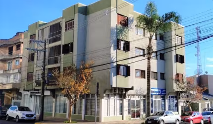 Apartamento no centro com 2 dormitórios, sala, cozinha, banheiro, área de serviço, sacada e garagem.  Área privativa de 73,21 metros.  Confira!