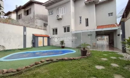 Casa com 3 quartos à venda na Rua dos Bem-te-vis, 56, Jardim Algarve, Alvorada, 173 m2 por R$ 730.000
