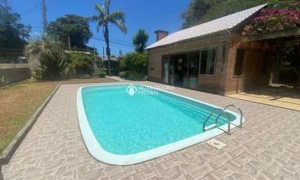 Casa com 3 quartos à venda na MAURA­CIO LESSA, 295, Flórida, Guaíba, 300 m2 por R$ 970.000