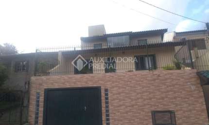 Casa em condomínio fechado com 3 quartos à venda na Rua Nova Araça, 67, Vila Augusta, Viamão, 190 m2 por R$ 500.000