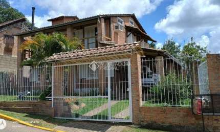 Casa em condomínio fechado com 4 quartos à venda na Rua Mogno, 24, Cantegril, Viamão, 190 m2 por R$ 550.000