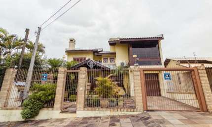 Casa em condomínio fechado com 4 quartos à venda na Travessa Porto Príncipe, 59, Jardim Lindóia, Porto Alegre, 304 m2 por R$ 1.650.000