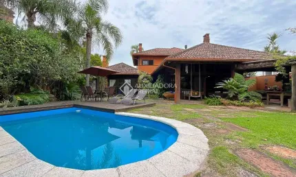 Casa em condomínio fechado com 6 quartos à venda na Avenida Juca Batista, 8000, Guarujá, Porto Alegre, 450 m2 por R$ 2.900.000