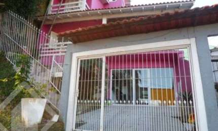 Casa em condomínio fechado com 3 quartos à venda na Rua Erechim, 70, Nonoai, Porto Alegre, 300 m2 por R$ 600.000