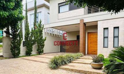 CASA EM CONDOMÍNIO DE 4 QUARTOS SENDO 3 SUITES PISCINA E 4 VAGAS DE GARAGEM.