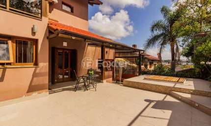Casa em condomínio fechado com 3 quartos à venda na Avenida Vicente Monteggia, 2000, Cavalhada, Porto Alegre, 260 m2 por R$ 1.224.000