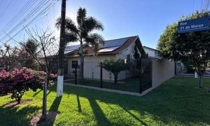 Casa de esquina com 170m², 1 suíte e 2 quartos, placas solares, cozinha planejada, 2 chuveiros, 2 vagas de garagem, despensa e lavanderia.