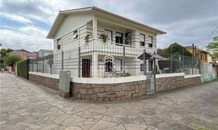 Elegance Imóveis vende casa / sobrado residencial ou comercial ampla com 4 dormitórios 2 vagas box garagem e ótimo pátio. Partenon Porto Alegre.
