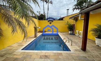 Casa à venda Martim de Sá com piscina, 2 dormitórios, sendo 1 suíte, sala com 2 ambientes e garagem