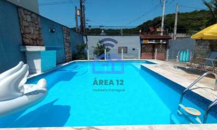Sobrado à venda no bairro Martim de Sá em Caraguatatuba, 3 dormitórios, 3 banheiros, piscina, área