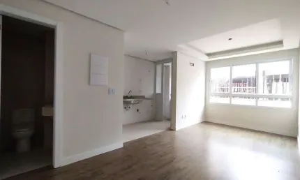 Apartamento 1 dormitório com suíte, cozinha americana, lavabo e amplo living no bom fim!