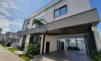 LINDA CASA NOVA EM CONDOMINIO FECHADO COM 4 SUÍTES E 4 VAGAS DE GARAGEM.