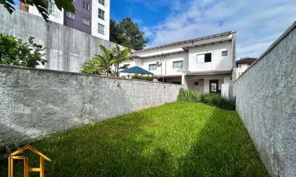 Sobrado geminado no Santo Antônio com amplo terreno de fundos, 2 vagas, 1 suíte + 2 quartos