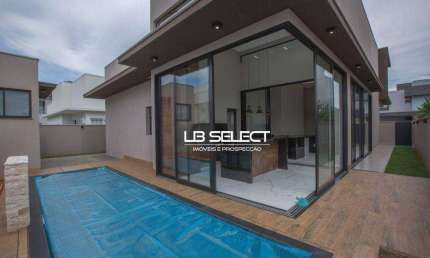 Casa no Condomínio Alphaville II com três suítes, escritório com lavabo e varanda gourmet completa.