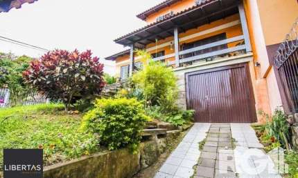 Casa com 5 quartos à venda na Rua Ângelo Passuelo, 79, Vila Nova, Porto Alegre