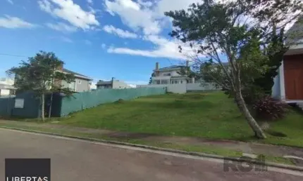 Terreno em condominio em porto alegre, no bairro vila nova, à venda.