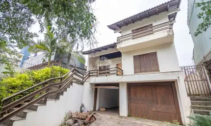 Sobrado comercial ou residencial, 3 dormitórios, sendo 1 suíte com closet e hidro, área intima com lareira. À venda no bairro Marechal Rondon/Canoas