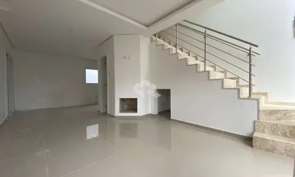 Sobrado NOVO 3 dormitórios, 1 suíte, 2 vagas de garagem, sala estar lareira, churrasqueira, pátio, sacada, água quente, São José/Canoas. Financia