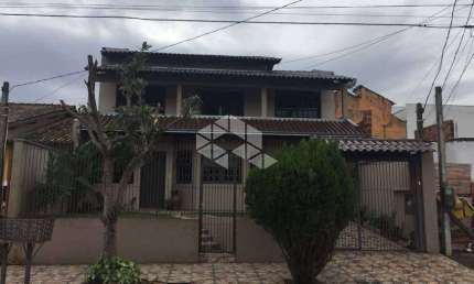 Casa 4 dormitórios sendo uma suíte e 4 vagas bairro Monhos de Vento, Canoas/RS.