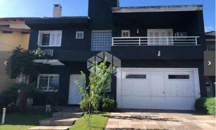 CASA EM CONDOMINIO 4 DORMITÓRIOS, 3  vagas, sendo 2 cobertas, segurança, piscina, trilha, churrasqueiras, bairro Lomba do Pinheiro em Porto Alegre.