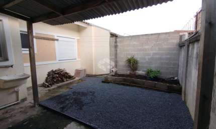 Casa com 2 dormitórios, pátio na frente e nos fundos em condomínio fechado