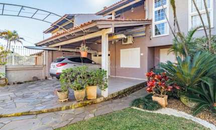 Casa com 3 quartos à venda na Rua Fortunato Della Casa, 45, Espírito Santo, Porto Alegre por R$ 959.000